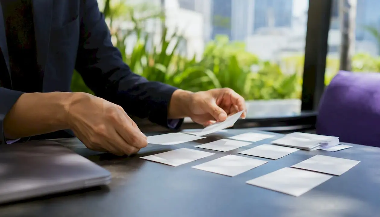 Hands sorting LinkedIn recommendation notes