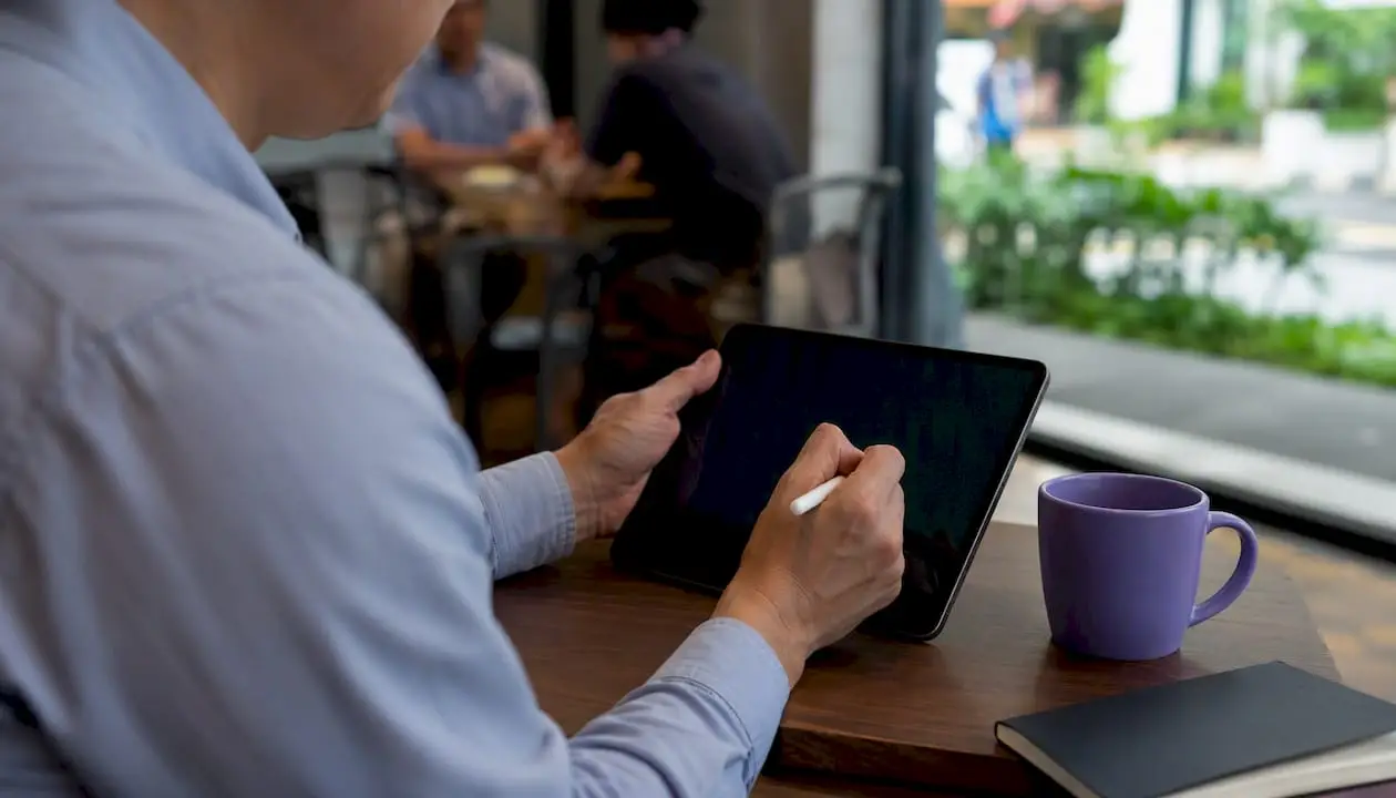 Hand writing LinkedIn recommendation bullets on tablet
