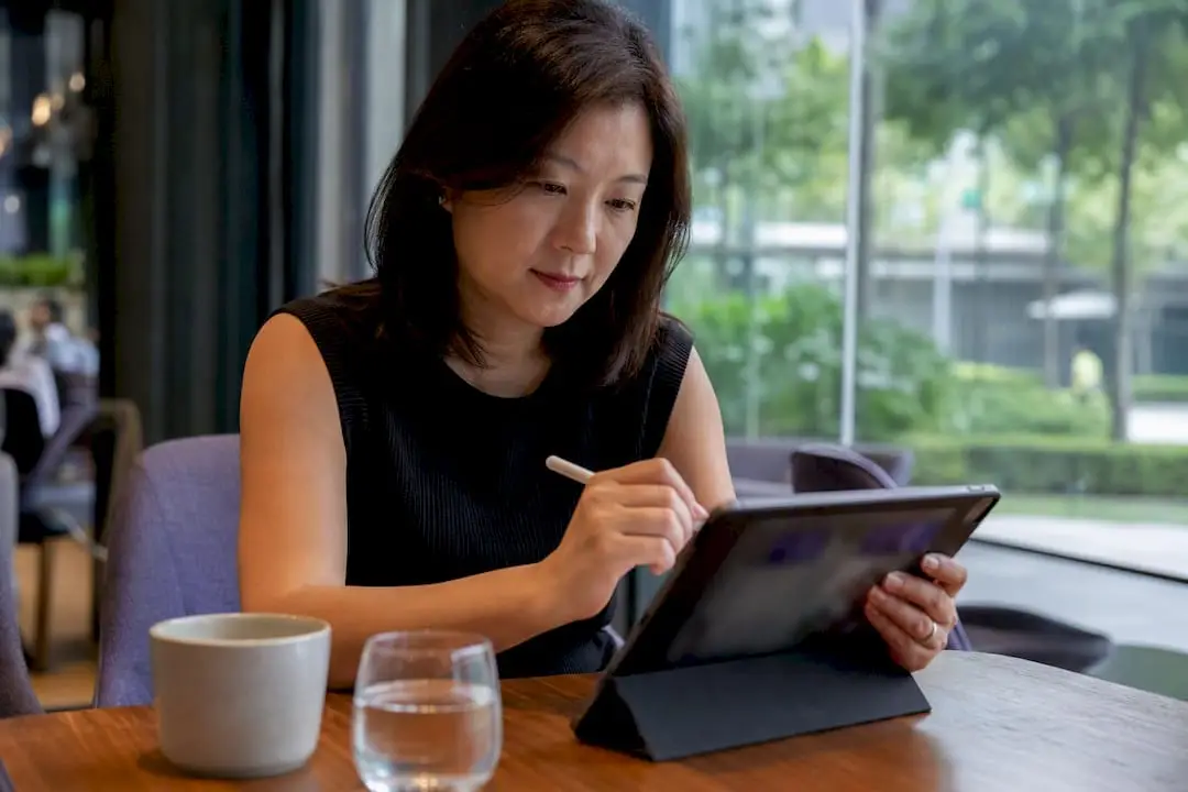 Hands editing LinkedIn banner on tablet