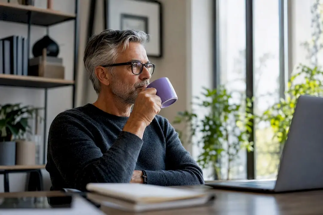 Senior tech leader pouring coffee in office