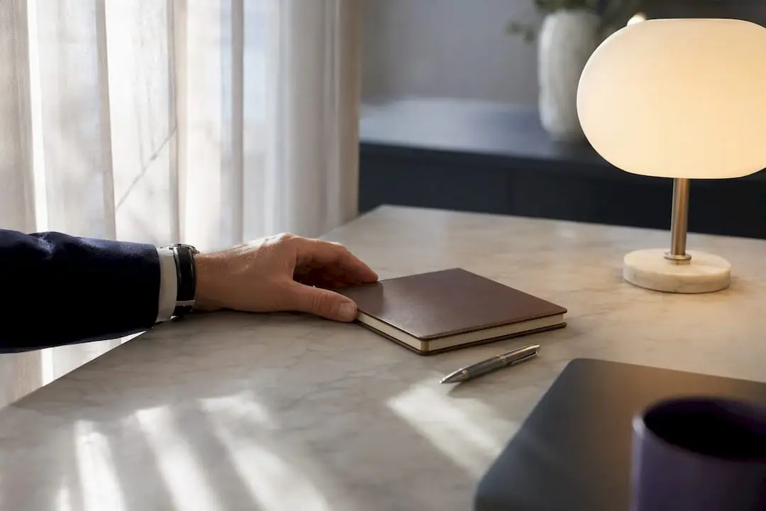 Hand placing paperweight to mark follow-up task