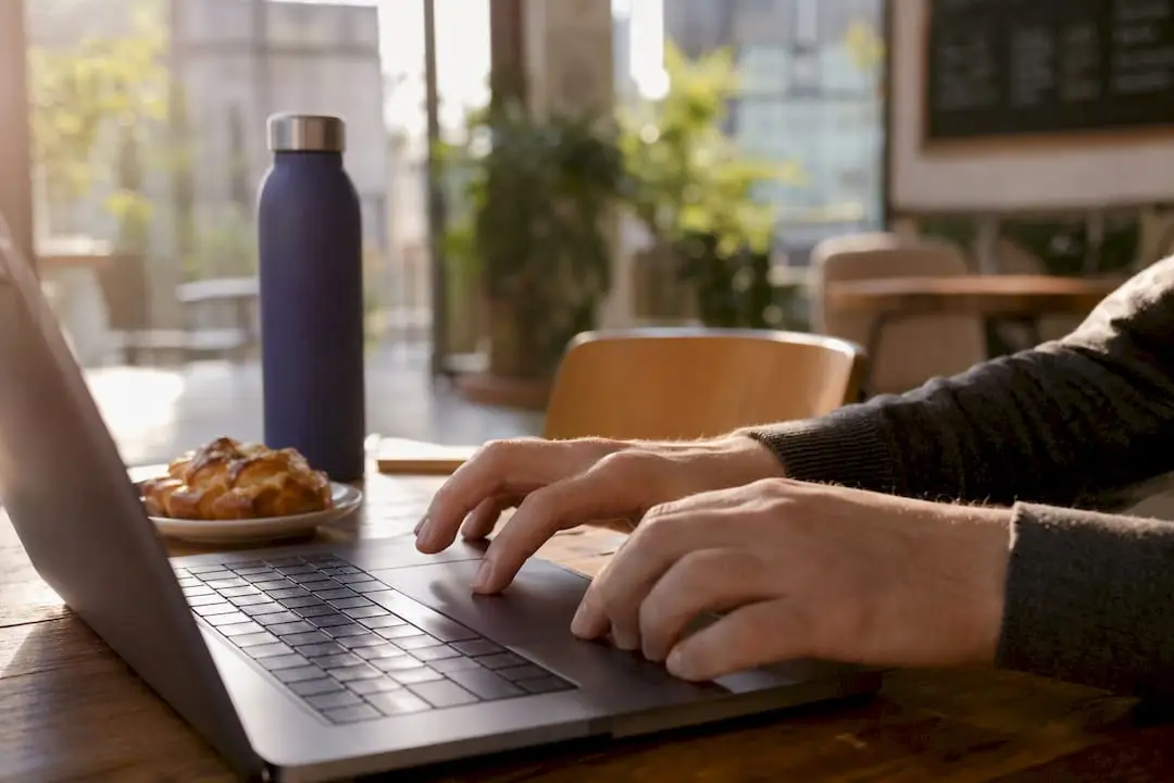 Hands clicking add featured section on laptop