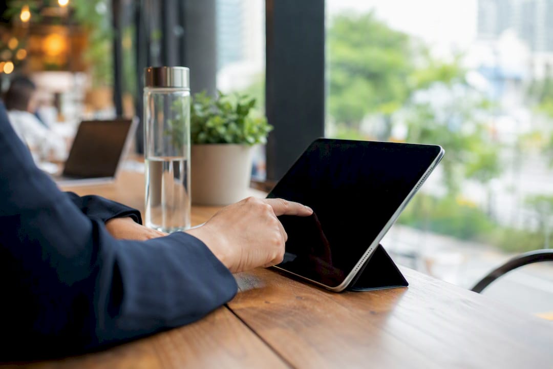 Hand writing on tablet selecting referral contact